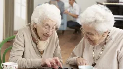 Two Senior Women Playing Dominos